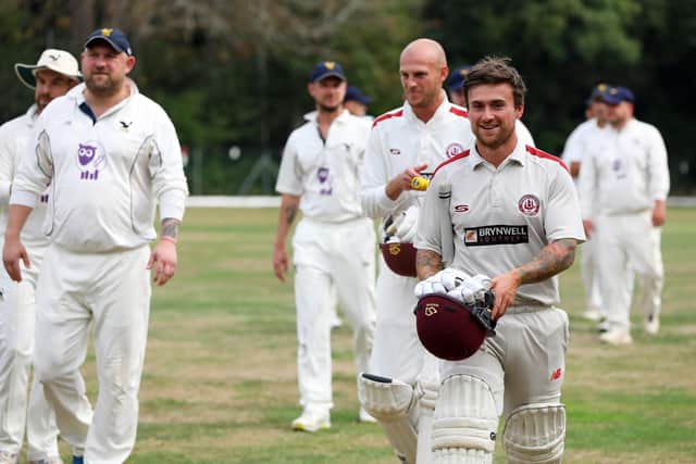 Portsmouth & Southsea's Jack Davies, front right, and Matt Benfield walk off after their side's nine-wicket thrashing of Purbrook. Picture: Chris Moorhouse