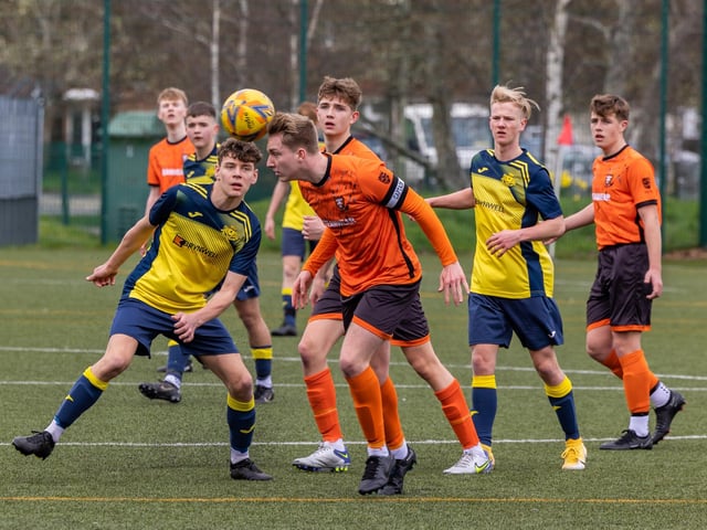 Action from the 2-2 draw between the under-18s of Moneyfields (blue/yellow kit) and AFC Portchester (orange/black kit). Picture: Mike Cooter