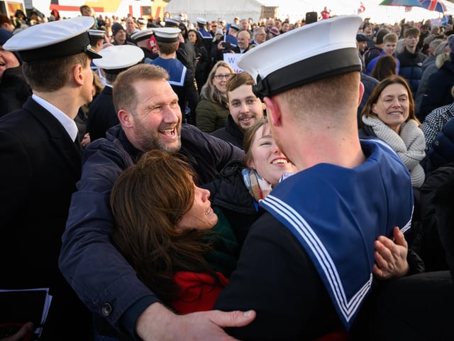 PORTSMOUTH, ENGLAND - DECEMBER 11: Naval personnel are greeted by family and friends following the return of the United Kingdom's biggest warship, the HMS Prince of Wales aircraft carrier, following a three months deployment, on December 11, 2023 in Portsmouth, Picture: Leon Neal/Getty Images