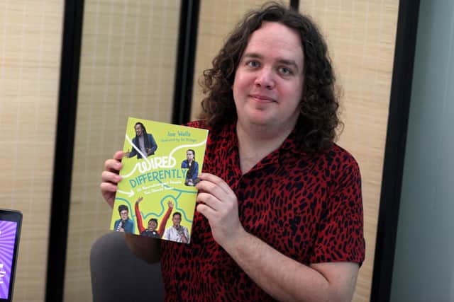 Portsmouth comic and author Joe Wells with a copy of his new book - Wired Differently, released May 2022. Picture by Ashleigh Spice