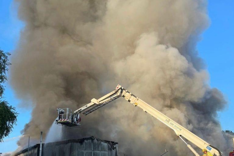 More than 80 firefighters were deployed to tackle a ferocious garage fire, which spread to nearby vehicles and buildings. Smoke could be seen filling the sky.