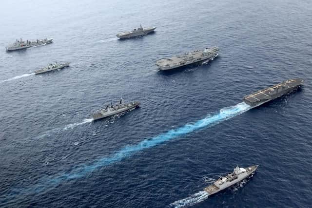 Pictured left to right: F-B RFA Tidespring, HMCS Winnipeg, HMS Defender, HNLMS Evertsen, JS Ise, HMS Queen Elizabeth, JS Izumo
