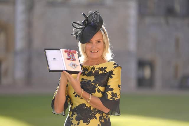 Dame Caroline Dinenage, MP for Gosport, holds her Dame Commander of the British Empire medal presented to her by the Princess Royal during an investiture ceremony at Windsor Castle, Berkshire. Picture date: Tuesday October 18, 2022. PA Photo.