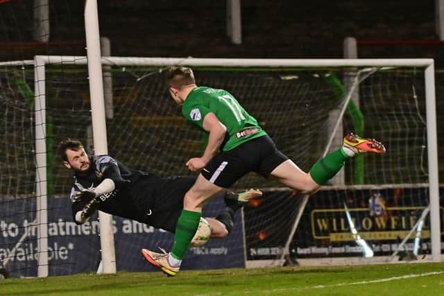 Pompey are looking overseas for talent after signing Glentoran's Terry Devlin.