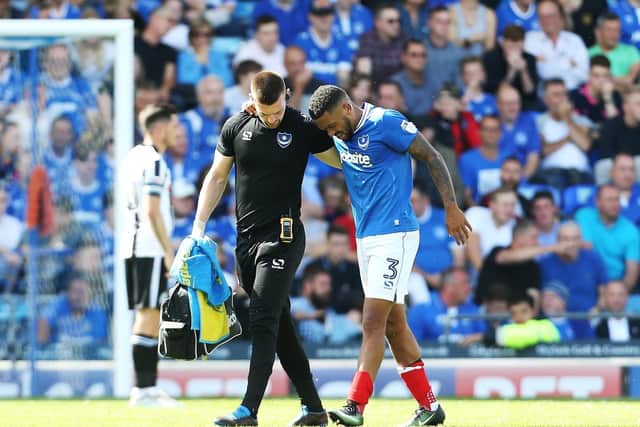 Tareiq Holmes-Dennis was forced off the pitch 39 minutes in his Pompey debut. The injury to his left knee would lead to his retirement just over three years later. Picture: Joe Pepler