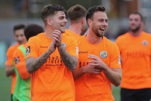 Hawks players clap the travelling fans after victory at Dorking. Picture: Kieron Louloudis