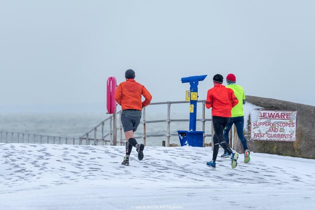 Snowy. Runners brave the conditions at Southsea seafront, Portsmouth during the Beast from the East. Picture: Shaun Roster