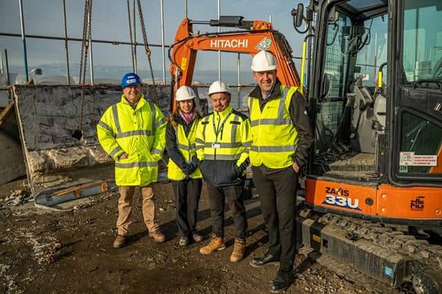 The council team on the roof of Horatia House with the first panel ready to be removed (from left) Meredydd Hughes, Amy Holmes, David Johnson and Steve Groves