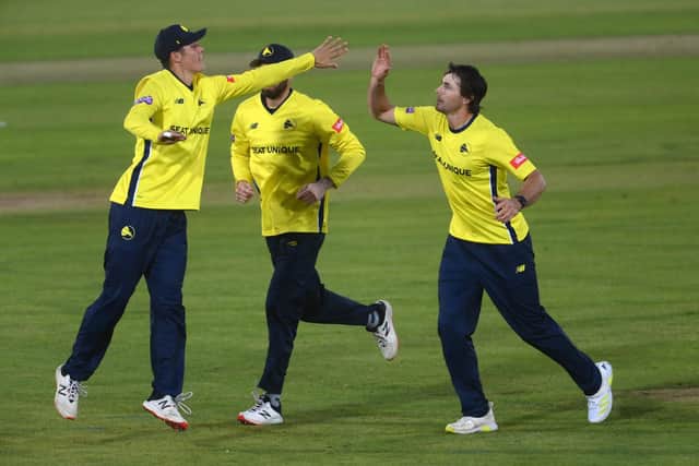Hampshire's James Fuller, right, celebrates with Brad Wheal after dismissing Adam Rossington. Photo by Mike Hewitt/Getty Images