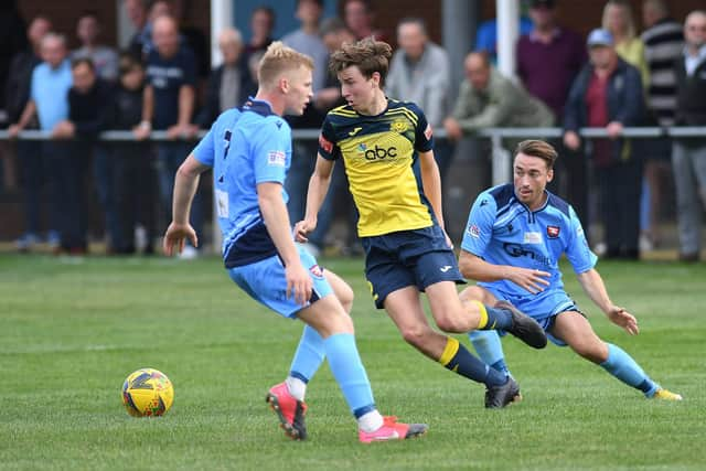 Moneyfields' Chad Cornwell takes on Aaron McCreadie, left, and Conor Bailey.
Picture: Neil Marshall