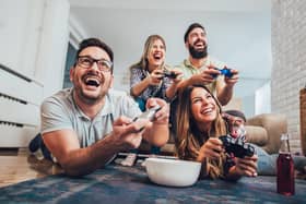 A group of friends playing video games together at home