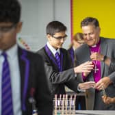Bishop Jonathan at Charter Academy with pupils Areen Saeed, left, and Christina Barnard