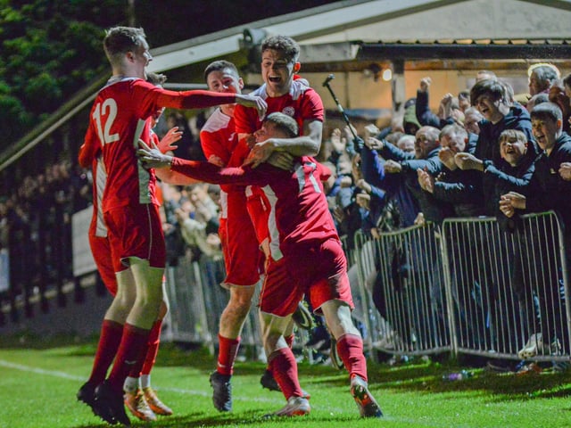 Horndean players celebrate Zack Willett's stoppage time winner. Picture by Martyn White