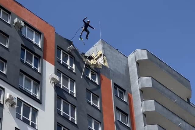 Ex Waterlooville paratrooper John 'The Flying Fish" Bream pictured base-jumping with a Ukrainian flag from the top of a bombed-out apartment block in the Ukrainian city of Bucha.