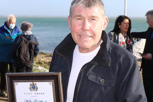 Willie Goldfinch with his civic award for his work setting up and tending to the Peoples' Memorial in Portsmouth. He was pictured on Wednesday before Storm Eunice hit. Photo: Phix-Pix Photo and Graphic Solutions www.phix-pix.com