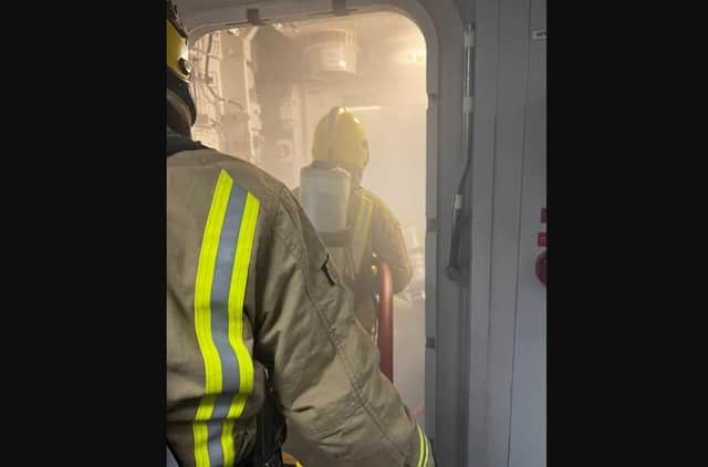 Crew tackling a firefighting training exercise onboard HMS Queen Elizabeth.
