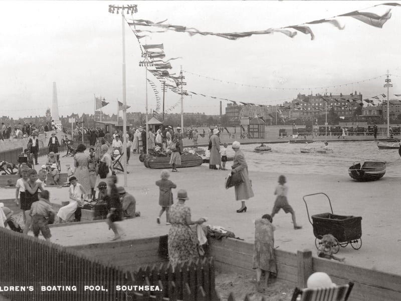 A windy day at the children's boating pool on Southsea Common. In the background you can see (from left) the obelisk of the naval war memorial, the power station chimney and the Queen's Hotel. The picture is undated but the fashions and the cars parked on the common indicate that we might be in the late 1920s or early 1930s. Picture: costen.co.uk