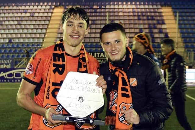 Josh Flint with former Pompey team-mate Leon Maloney (right) after securing promotion to the Eredivisie in April 2022, following a 2-1 triumph over Den Bosch.