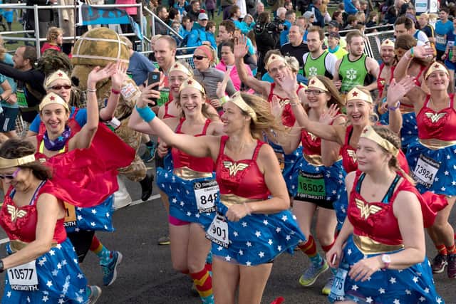 171189 - Great South Run - The Green wave runners start the race  - Wonder Women Picture: Vernon Nash