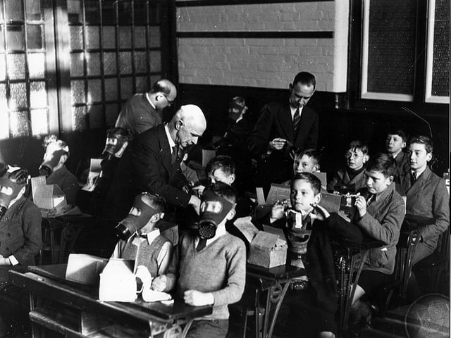Children are taught to put on their gas masks at a school in Highland Road, Eastney.