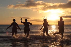 Nudists take part in the annual North East Skinny Dip as the sun rises at Druridge Bay in Northumberland. Photo by Lindsey Parnaby/AFP via Getty Images