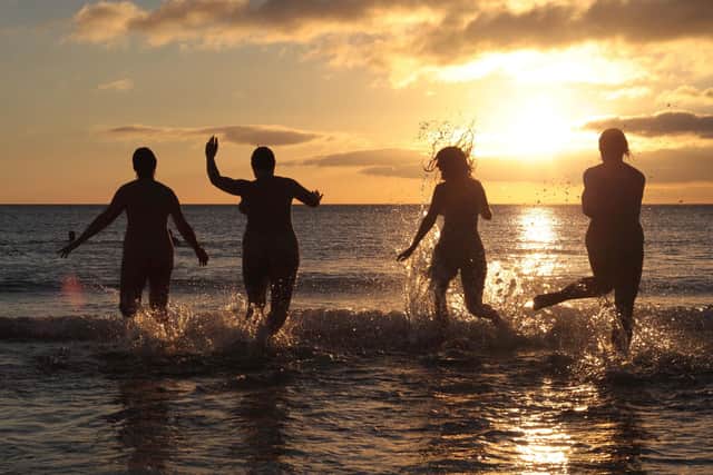 Nudists take part in the annual North East Skinny Dip as the sun rises at Druridge Bay in Northumberland. Photo by Lindsey Parnaby/AFP via Getty Images