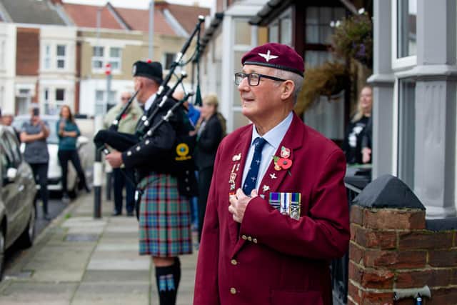 Andy Long humming along to Bill Tasker playing the bagpipes.
Picture: Habibur Rahman