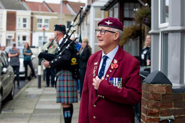 Andy Long humming along to Bill Tasker playing the bagpipes.

Picture: Habibur Rahman