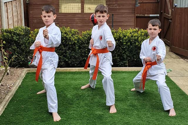 Ready for action - karate brothers Mark Hague, 10, left, with Myles, nine, and Riley, seven, right. Photo: Pauline Hague