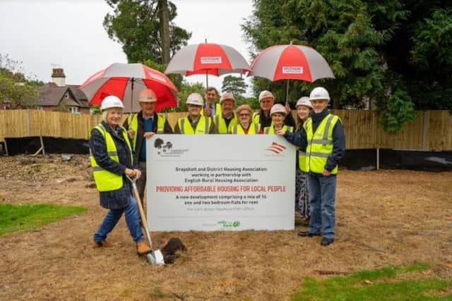 Charity representatives at the start of the affordable housing project.