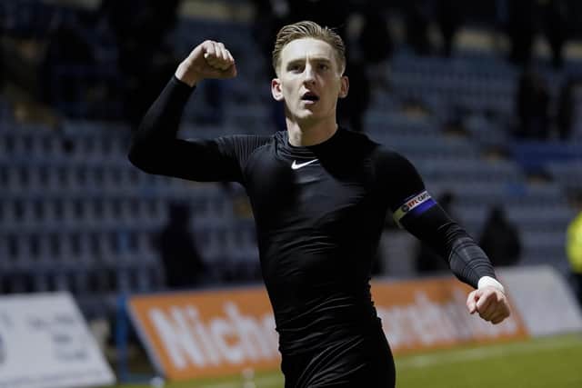 Ronan Curtis salutes the travelling Fratton faithful at the final whistle at Priestfield - after handing one lucky young Pompey fan his match shirt from the 1-0 win    Picture: Jason Brown