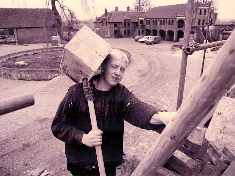 Labourer Mark Jackson from Funtington carries bricks to the team restoring the old Home Farm buildings at Cams Hall, Fareham in January 1993. The News PP116
