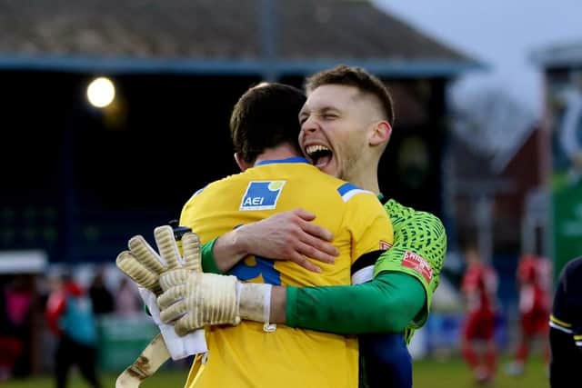 Goalkeeper Pat O'Flaherty celebrates with two-goal hero Dan Wooden. Picture by Tom Phillips