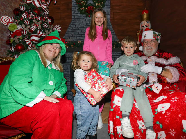 Children, from left, Laya, 2, Hattie, 9, and Arnie, 4 meet Father Christmas and one of his elves. Leigh Park Christmas grotto at Greywell Shopping Centre, Leigh Park, Havant Picture: Chris Moorhouse (jpns 251123-40)