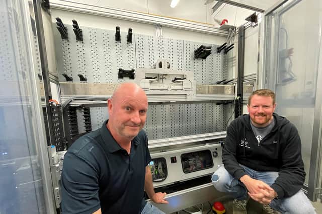 Dave Bowyer, left, and Steve Kennington, co-founder of Lumico Digital, with part of the company’s robotics retrieval system for newly manufactured stored hard drives ready to be shipped from South-East Asia.