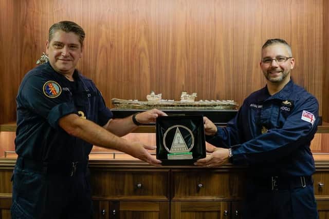 Warrant Officer 1 Sam Hogg, right, pictured with Rear Admiral Mike Utley picking up his award. Photo: Royal  Navy