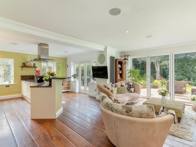 The open plan kitchen diner is modern in design, with integrated appliances, quartz worktops and a family breakfast bar.