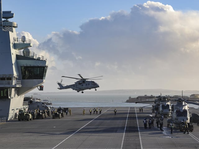 A Merlin Mk4 from 845 NAS lands on the flight deck.