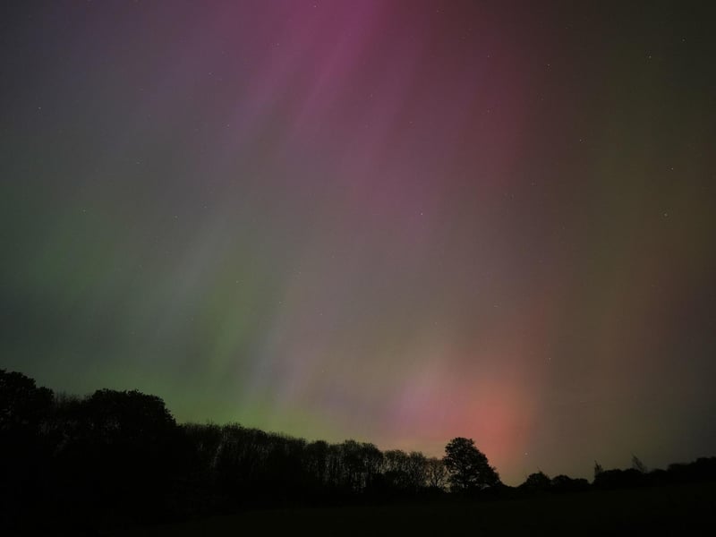 The aurora borealis, also known as the northern lights, glow on the horizon over Basingstoke in Hampshire.