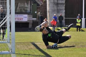 Tom Price dives to save Billy Walker's penalty during US Portsmouth's shoot-out victory over Christchurch. Picture: Martyn White.