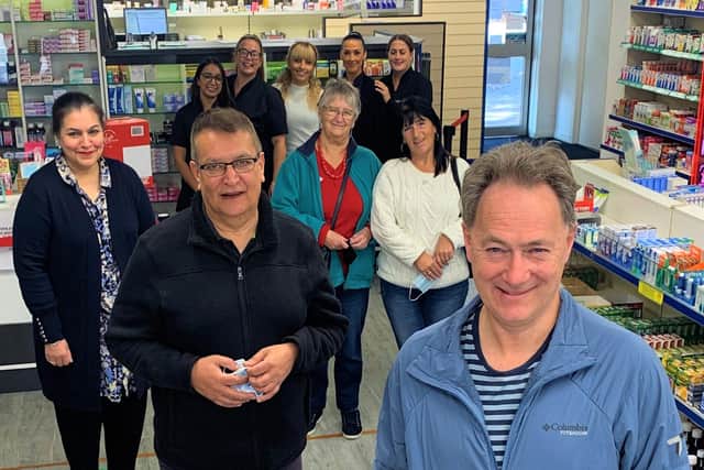 Mr and Mrs Laly (left) bid a fond farewell to Dr Ian Morris (right) with staff and customers at their Kingston Road branch in Fratton. 