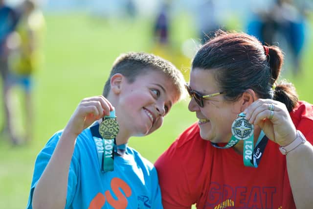 Big smiles as this young lad shows off his medal. Photo: Peter Langdown