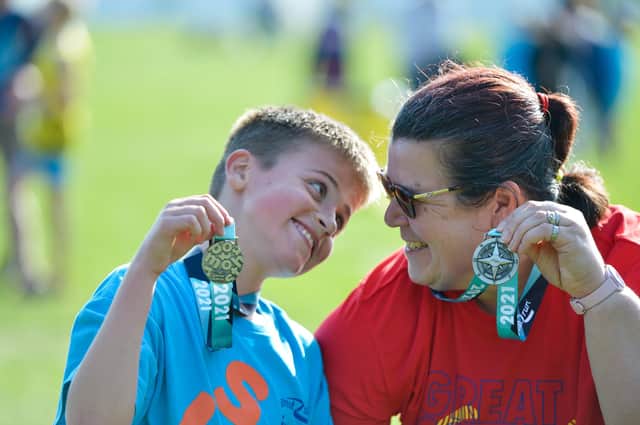 Big smiles as this young lad shows off his medal. Photo: Peter Langdown