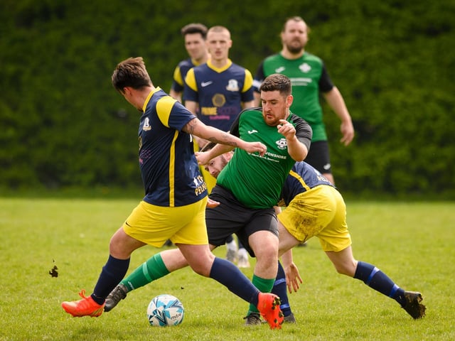 Action from Saturn Royale's 1-0 win over Pelham Arms (blue and yellow kit) in the second Adelaide Cup semi-final. Picture: Keith Woodland (300421-614)