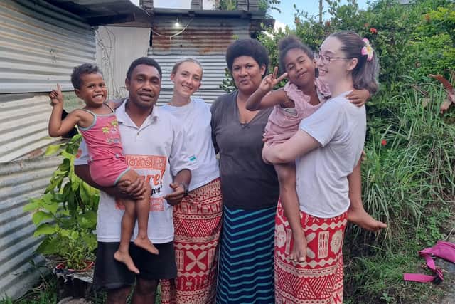 Bobby's, right, with another volunteer, and their host family