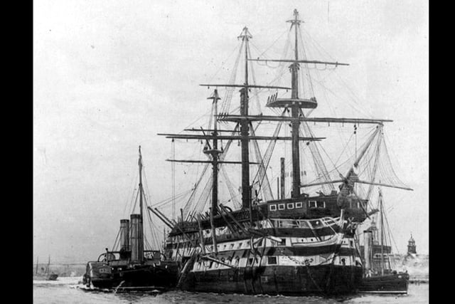 De-masted three decker in Portsmouth Harbour.This marvellous photograph of a Nelsonian/Napolionic wooden wall was loaned to us by William Tofts of Copnor. We don't believe it to be HMS Victory but could be. Steam tugs are alongside.