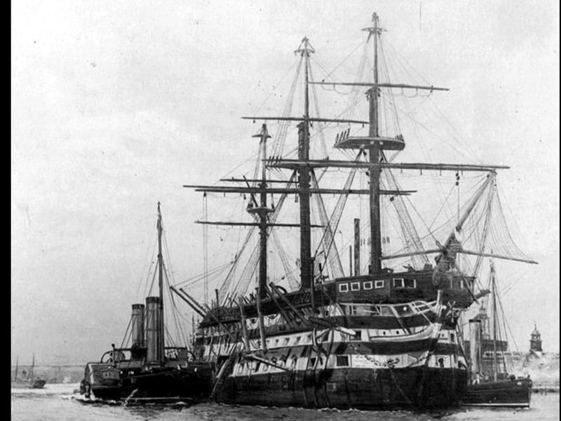 De-masted three decker in Portsmouth Harbour. This marvellous photograph of a Nelsonian/Napolionic wooden wall was loaned to us by William Tofts of Copnor. We don't believe it to be HMS Victory but could be. Steam tugs are alongside.
