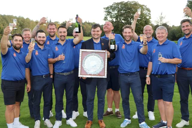 Lawrence Cherry holds the Daily Telegraph Salver after his Hampshire team celebrate winning the South East League Final. Picture by Andrew Griffin.