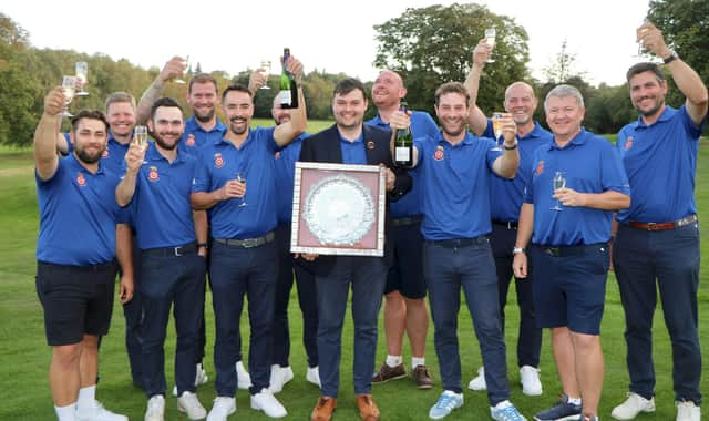 Lawrence Cherry holds the Daily Telegraph Salver after his Hampshire team celebrate winning the South East League Final. Picture by Andrew Griffin.