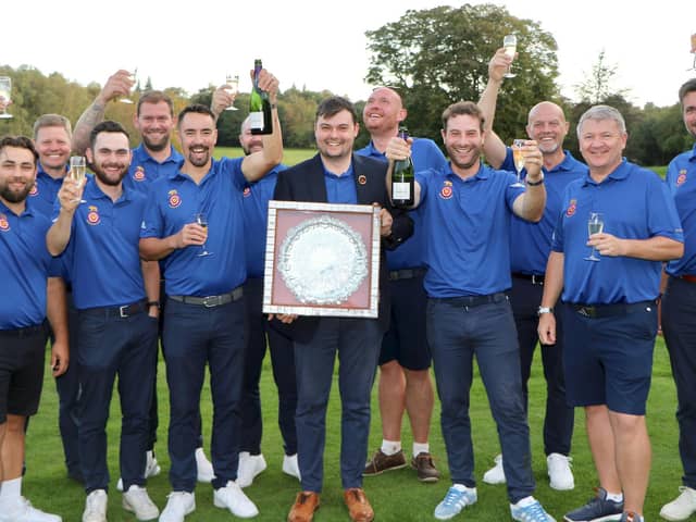 Lawrence Cherry holds the Daily Telegraph Salver after his Hampshire team celebrate winning the South East League Final. Picture by Andrew Griffin.